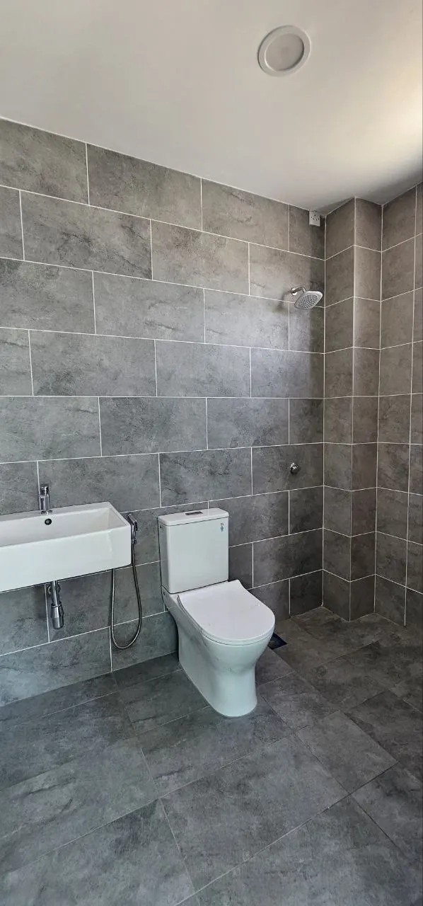 Bathroom of the Ampang Cove semi-D, tiled floor to ceiling