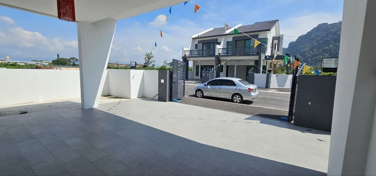 Car porch of the Ampang Cove semi-D with limestone hills beyond