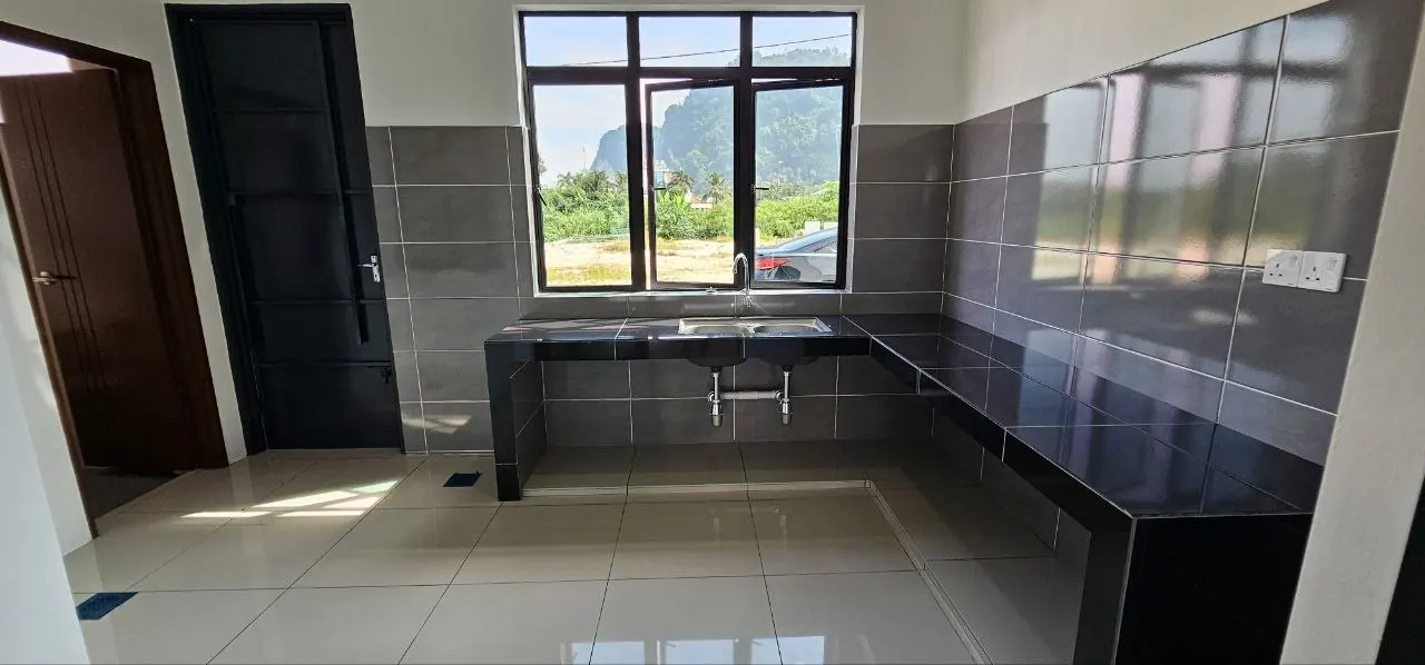 Kitchen of the Ampang Cove terrace unit with a cast counter and window