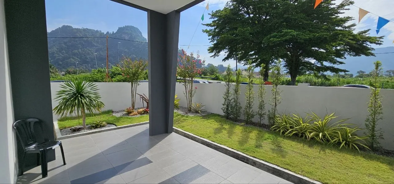 Rear garden of the Ampang Cove terrace unit with limestone hills in the distance