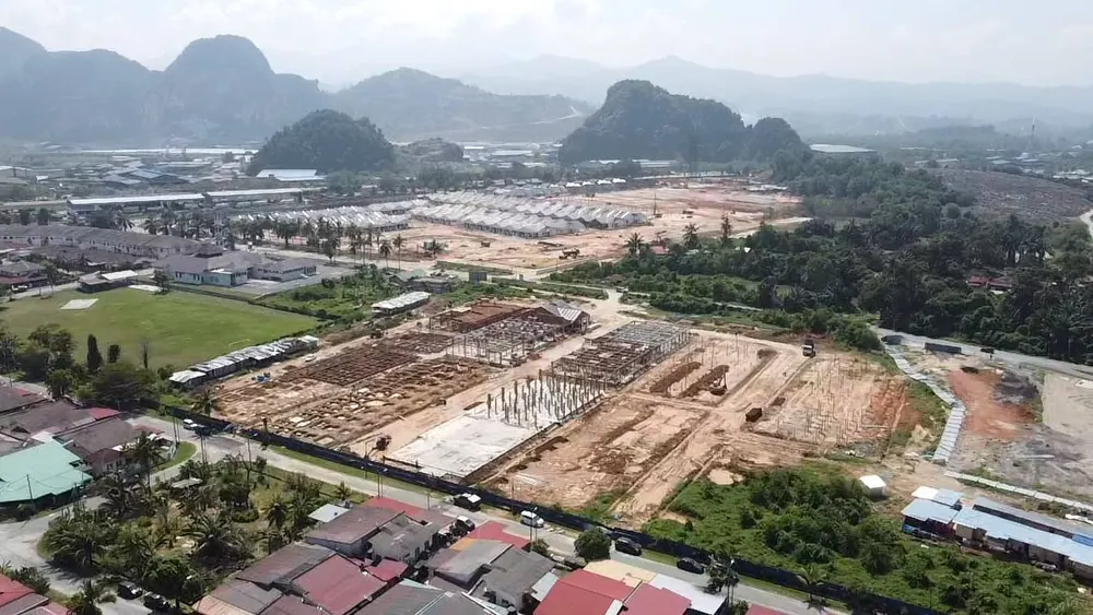Taman Raia Saujana III from above — the site sits among existing housing, with the limestone hills behind