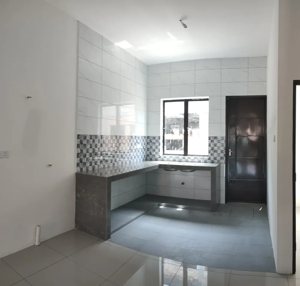 Kitchen — counter cast, tiled splashback, window over the sink